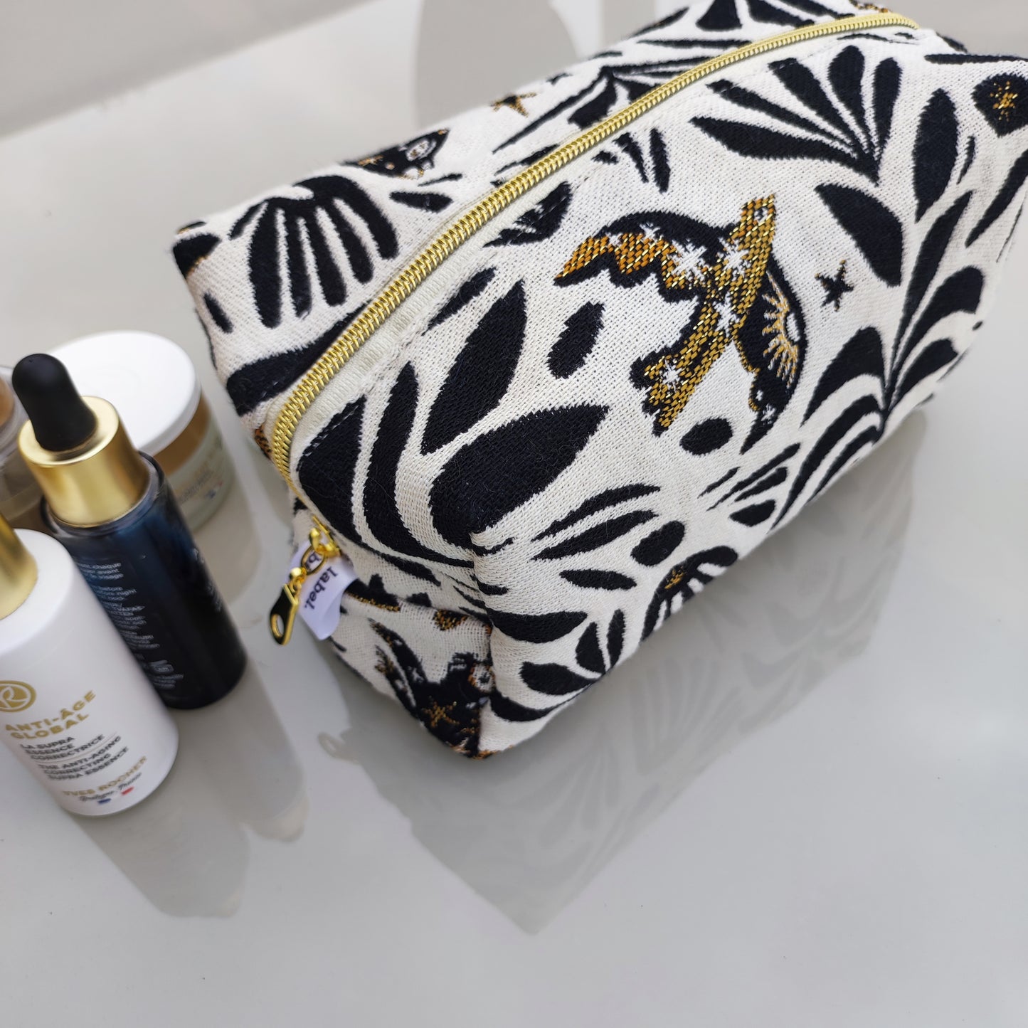 Trousse de toilette Mystic fond blanc motif noir et or